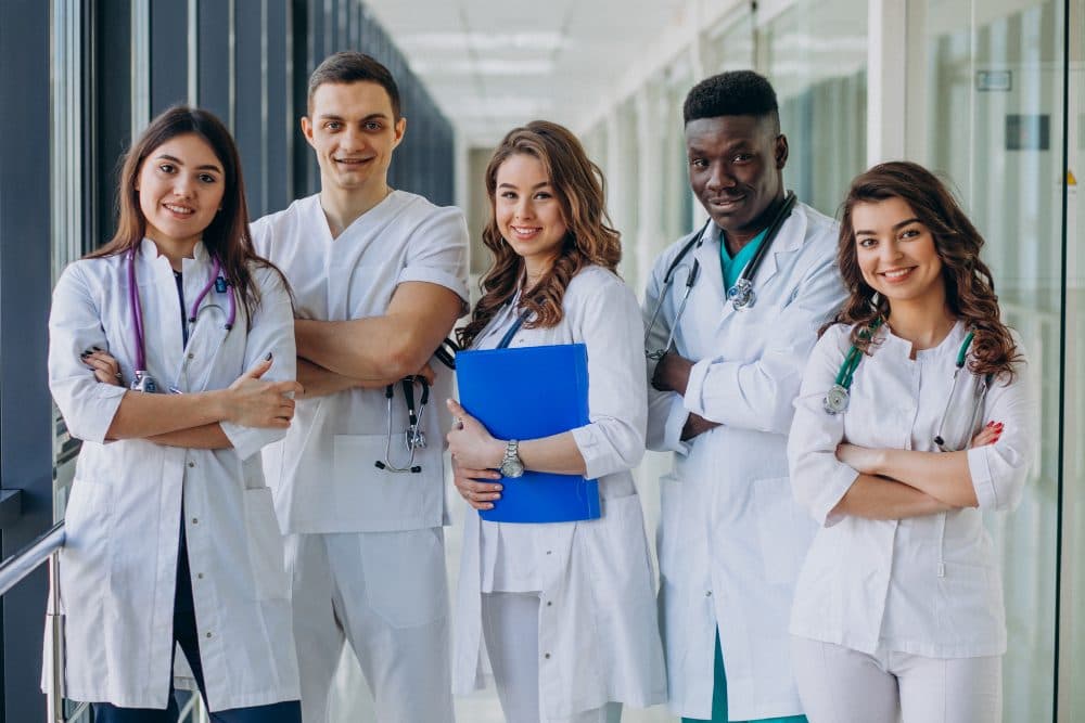 Team of young doctors standing in a hospital corridor