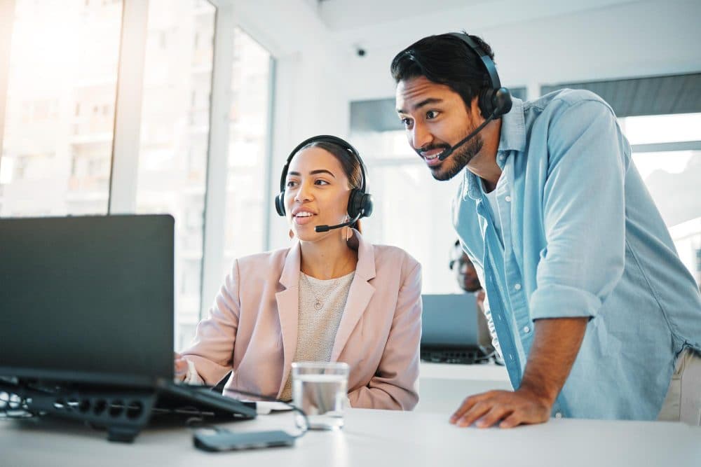 Support team members working together at a desk