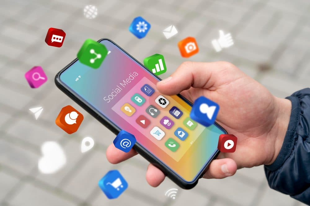Phone surrounded by social media and marketing icons