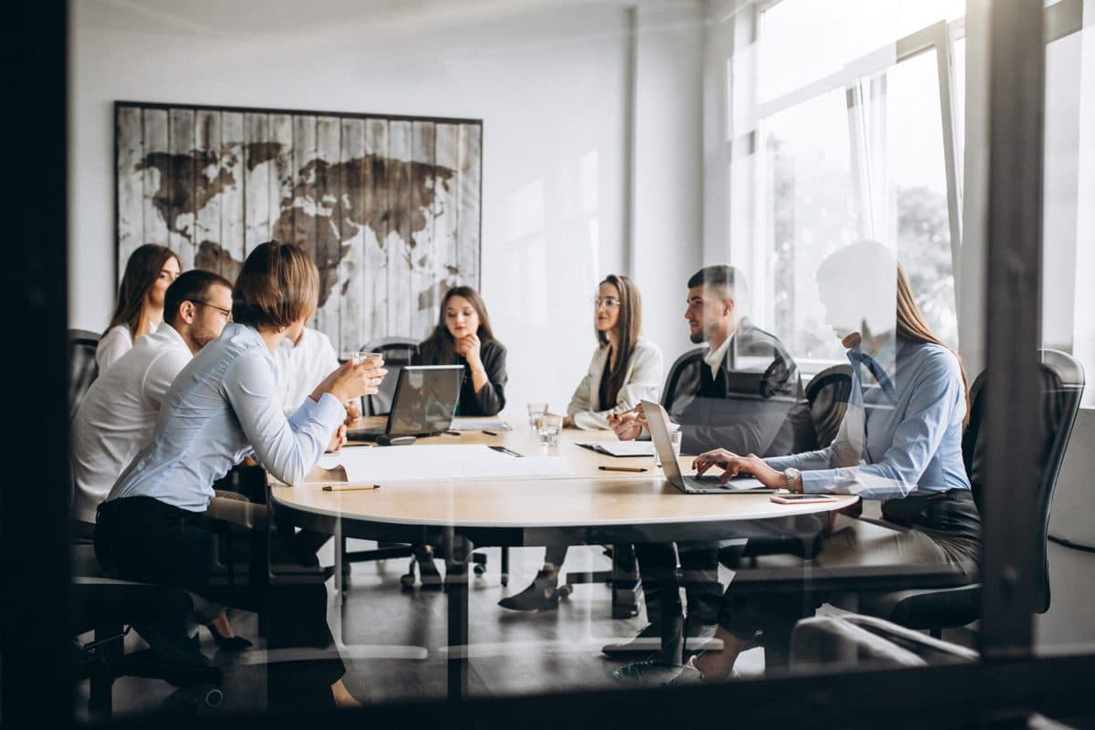 Team in a meeting room discussing a business plan